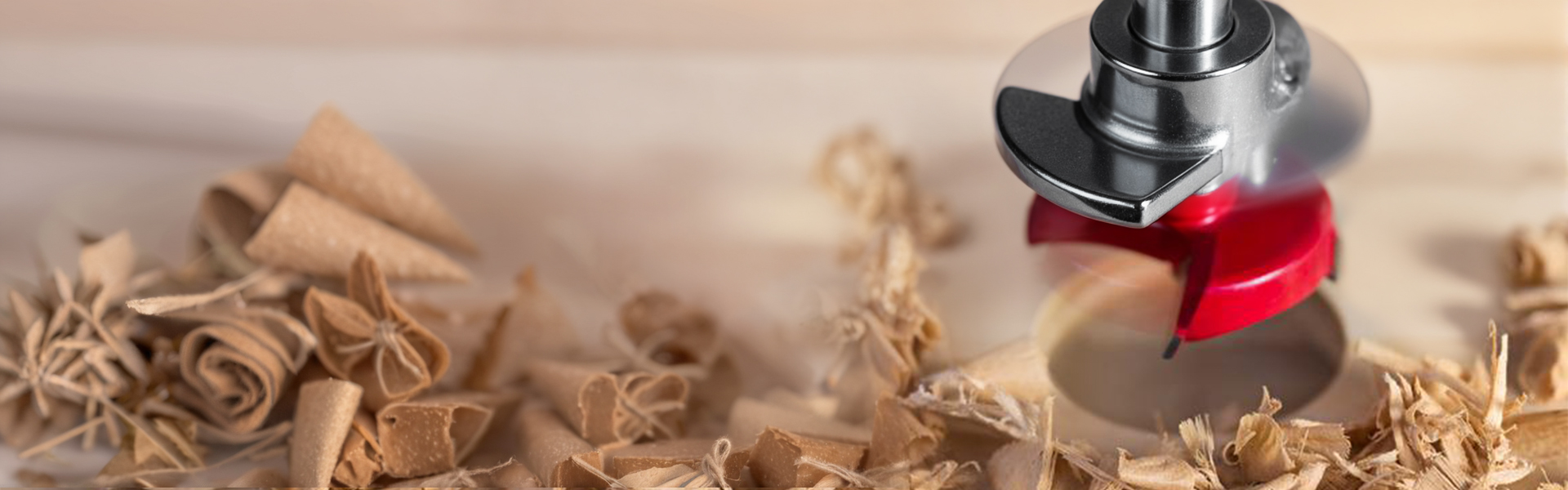 Red router bit cutting through wood with precision shavings